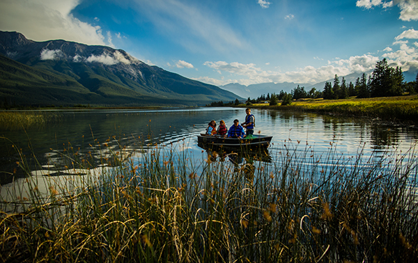 Group in rowboat on Talbot Lake surrounded by reeds
